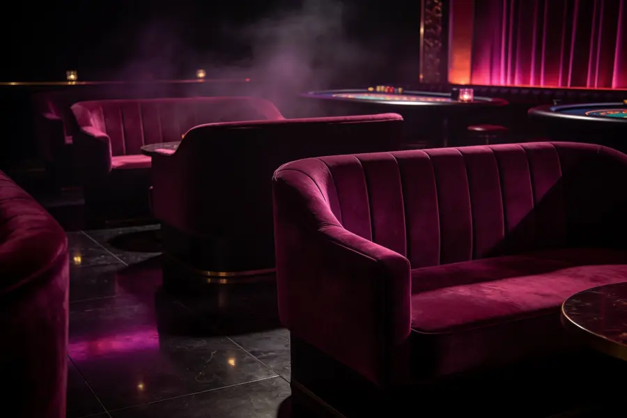 Empty modern casino lounge at night lit in deep plum and magenta